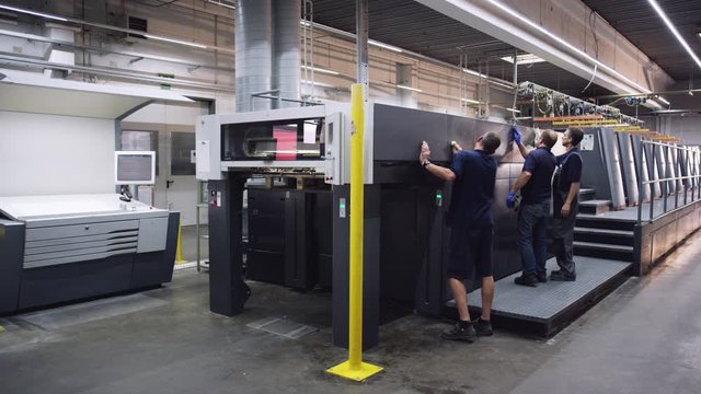Druckmaschine wird von Arbeitern gesäubert - Printing maching is getting cleaned by workers