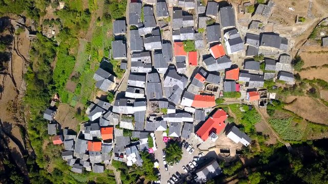 Aerial, birdseye, drone shot, above the Piodao town, in Serra do Acor, in Serra da Estrela natural park, on a sunny, summer day, in Portugal