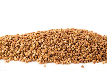 Raw uncooked buckwheat seeds on white background
