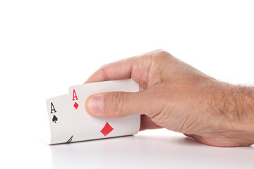 man\'s hand showing pair of  aces, diamonds and spades,  poker cards isolated on white background with copy space for your text