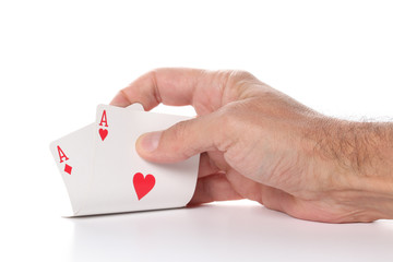 man\'s hand showing pair of  aces, hearts and diamonds,  poker cards isolated on white background with copy space for your text