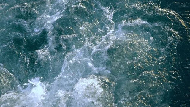 Blue sea water with boat trace. Slow motion.