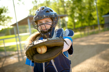A children baseball catcher players standing on the playground