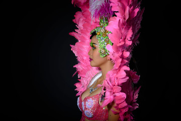 Cabaret Show Dancer in pink suit with rhinestones standing on the side on black isolated with copy space