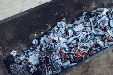 Burning coals in the grill. Shallow depth of field.