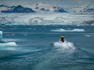 The man is sailing on a speedboat on Jökulsárlón lake