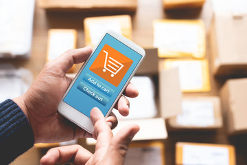 Online shopping concepts with youngman using smartphone for payment his order on a lot of product package box.Ecommerce market.Business retail