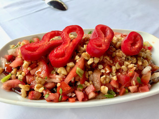 Turkish Salad Gavurdagi with Walnut, Tomatoes and Sliced Red Peppers Slices.