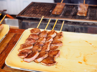 Closeup detail of Yakiniku Kushiyaki flame-grilled beef skewers sold at a street stall. Chiyoda, Tokyo, Japan. Travel and cuisine.