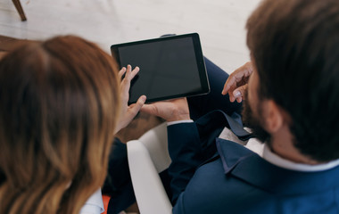couple using digital tablet in city