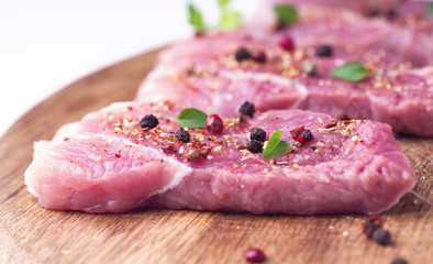 Steaks sprinkled with spices and herbs. Juicy steaks for a barbecue close up.