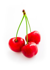 Colorful three delicious cherries, isolated on white background, natural shadow.