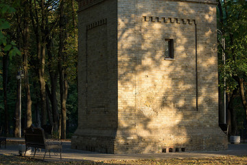 Old stone tower among the trees in the park.