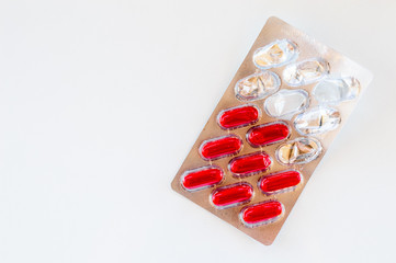 Red capsules packed in a blister pack isolated on white background