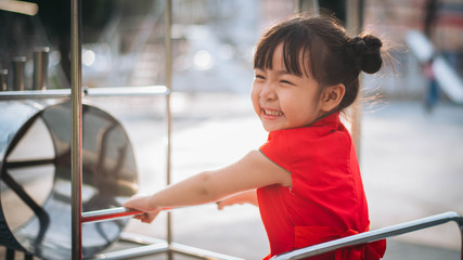 asian girl playing in playground 