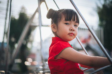 asian girl playing in playground 