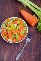 Fresh salad from stalks of celery, carrots, apples and cheese. Fitness breakfast, healthy.
