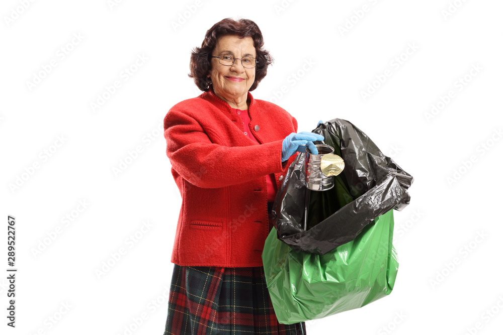 Poster Mature woman throwing a tin can in a garbage bag