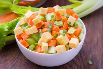 Fresh salad from stalks of celery, carrots, apples and cheese. Fitness breakfast, healthy.