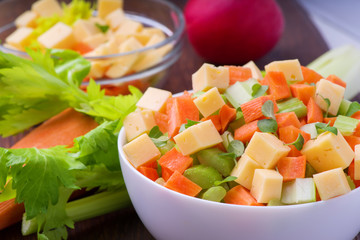Fresh salad from stalks of celery, carrots, apples and cheese. Fitness breakfast, healthy.