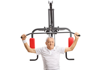Fototapeta na wymiar Mature man exercising on a fitness machine