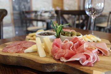 ham and salami on wooden board