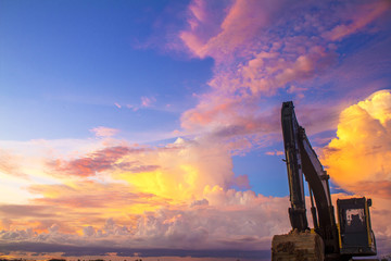 silhouette of excavator at sunset