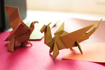 origami dragon and eagle on a colorful background