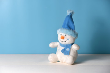 Christmas background with toy snowman on a blue background