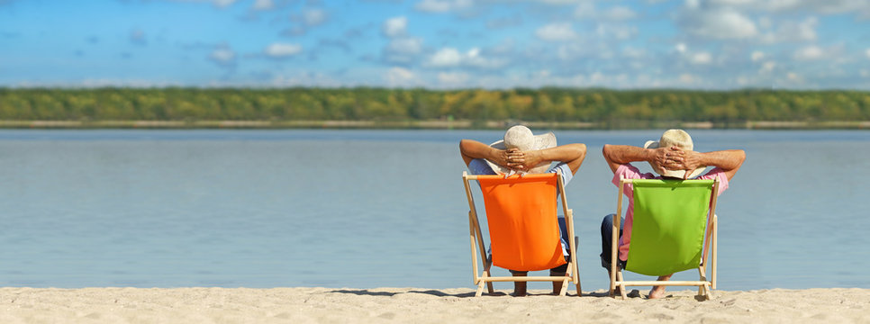 natural beach with deck chairs in the sand - holiday relax concept