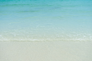 Fototapeta na wymiar Close-up wave of blue sea on the beach.