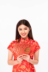 Smiling chinese girl dress traditional cheongsam holding red envelope