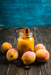 Fresh peach juice with cinnamon spices in jar. Selective focus. Shallow depth of field.