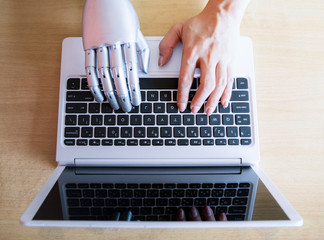 Robot hands and fingers point to laptop button advisor chatbot robotic artificial intelligence...