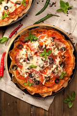 Pizza with sausage, olives and cheese.