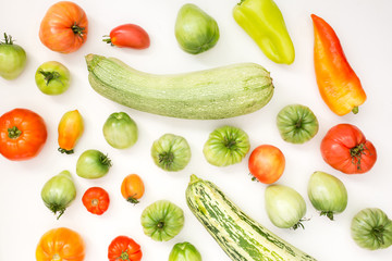 Summer harvest of vegetables concept. Set of green and red peppers, tomato and zucchini.