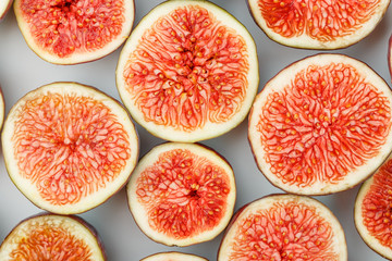 Figs are ripe. Creative diagram of chopped figs on a white background in the form of a texture inscribed in a rectangle. Soft contrast