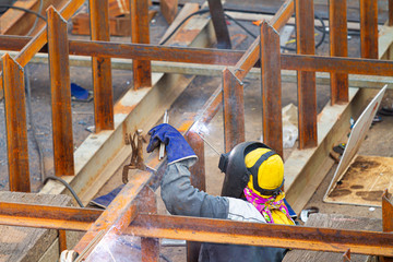 Industrial welder welding fabricated construction in factory