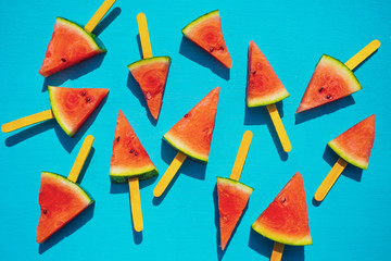 Fresh watermelon slices on the blue background. Summer fruit concept.