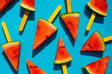 Fresh watermelon slices on the blue background. Summer fruit concept.