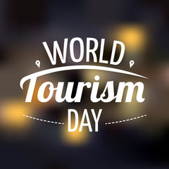 World Tourism Day card design with lettering on the blurred background. Vector illustration for card, postcard, banner, poster.