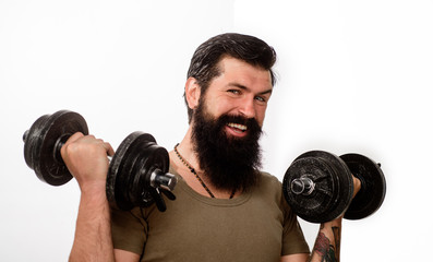 Fototapeta na wymiar Bearded man with dumbbells. Man with dumbbell during an exercise. Fitness man with dumbbell in gym. Strong handsome sport man making weightlifting. Muscular fitness model workout with dumbbell.