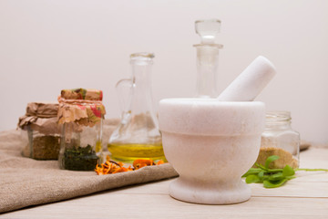 stone white cupola for spices, various bins with teas on the background, seasonal colds prophylaxis, natural medicine, preparation of potions, copy space, light background