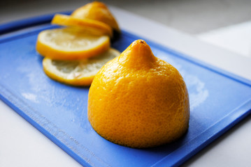 sliced lemon on a blue chopping Board