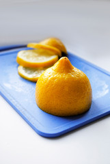 sliced lemon on a blue chopping Board