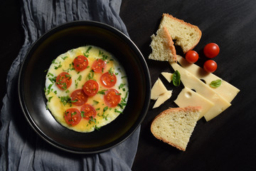 Fried eggs with tomatoes in a frying pan.Tasty and healthy food.