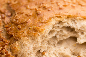 Bun with sesame seeds. Close up . Texture of brown bread with sesame. 