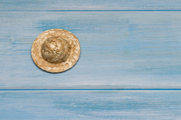 Fototapeta na wymiar Top view straw hat on blue background. Flat lay with copy space 