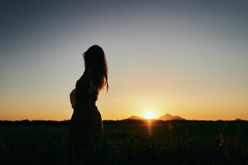 silhouette of woman in sunset