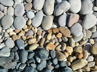 Yellow, Black and Grey pebbles on the beach